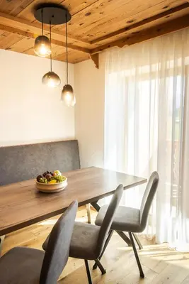 a dining room table with chairs and a bowl of fruit at Ciasa Sabine in Antermoia