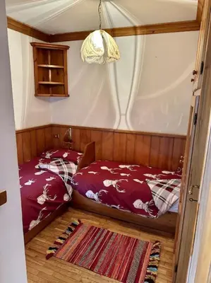 a small bedroom with a bed and a rug at Appartamento da Zambon in San Vito di Cadore