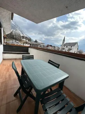 a table and chairs on a balcony with a view at Appartamento da Zambon in San Vito di Cadore