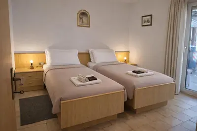 a bedroom with two beds with towels on them at La casa sul giardino in Castello di Fiemme