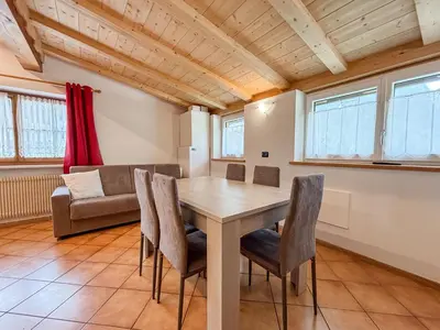 a dining room with a table and chairs at Chalet Vernel in Canazei