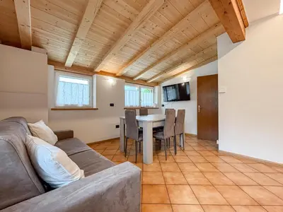 a living room with a couch and a table at Chalet Vernel in Canazei
