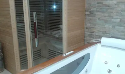a bathroom with a shower and a white tub at Azalea in Canazei