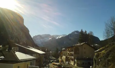 a view of a city with mountains in the background at Azalea in Canazei