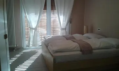 a bedroom with a bed in front of a window at Azalea in Canazei