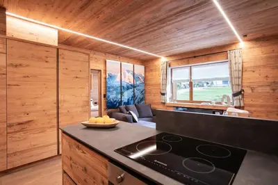 a kitchen with a stove top oven in a room at Appartamento Le Due Cime a Pozza di Fassa TRENTO in Pozza di Fassa