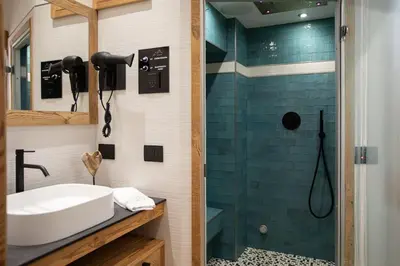 a bathroom with a sink and a shower at Appartamento Le Due Cime a Pozza di Fassa TRENTO in Pozza di Fassa