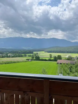 a view of a green field from a porch at Grasspeintenhof Reiterhof in Falzes