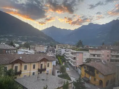 a view of a city with buildings and mountains at Thermae Apartment in Merano