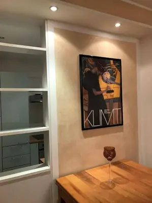 a dining room with a table and a picture on the wall at Thermae Apartment in Merano