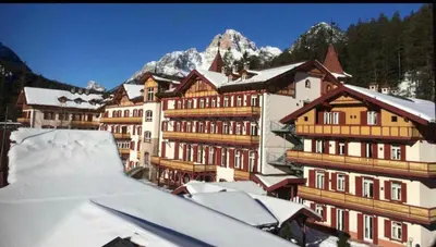 a group of buildings with snow covered roofs at Chalet con vista villaggio ploner in Dobbiaco