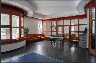 a living room with a table in the middle of a room at Chalet con vista villaggio ploner in Dobbiaco