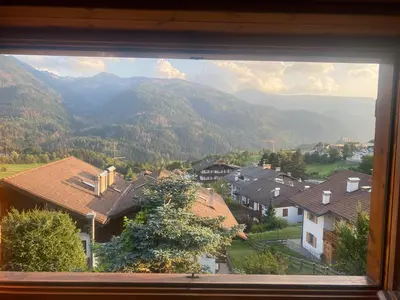 a view from a window of a village with mountains at Chalet Genziana in Cavalese