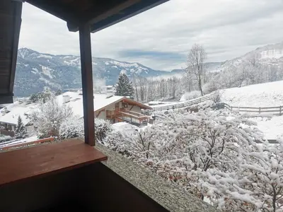a view of a snow covered mountain from a balcony at Chalet Genziana in Cavalese