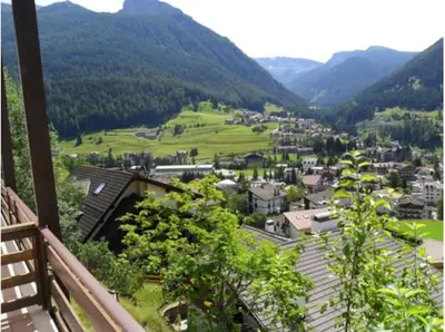 a view from the balcony of a town in the mountains at Moena Appartamento Fior di Melo con WiFi e Riscaldamento in Moena