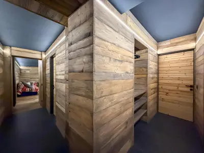a walk in closet with wood paneled walls at Duo Charme in Moena