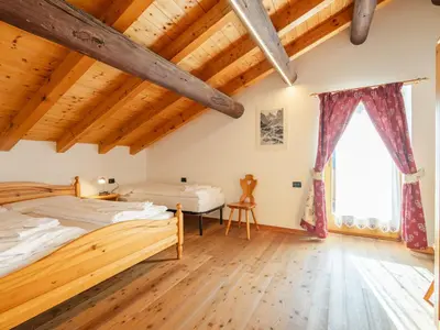a bedroom with two beds and a window at Apartment Casa Costazzer A by Interhome in Mazzin
