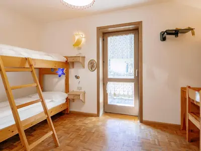 a bedroom with two bunk beds and a window at Apartment Fontanelle-3 by Interhome in Alba di Canazei