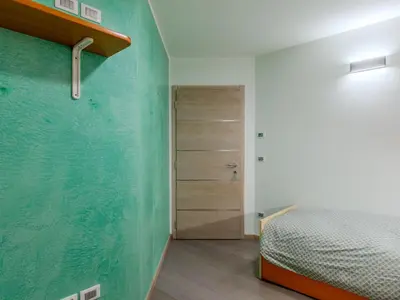 a kitchen with wooden cabinets and a sink at Apartment Elisa by Interhome in Ronzone