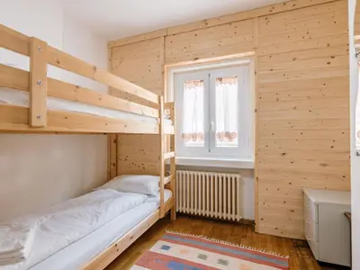 a bedroom with two bunk beds and a window at Apartment Cesa Giordi by Interhome in Canazei