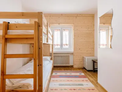 a room with two bunk beds and a rug at Apartment Cesa Giordi by Interhome in Canazei