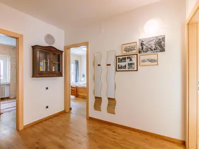 a room with a wall with paintings on it at Apartment Cesa Giordi by Interhome in Canazei