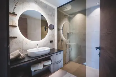 a bathroom with a sink and a mirror at Der Hof - Perntal Retreat in Gais