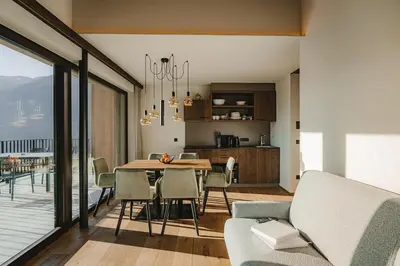 a kitchen and dining room with a table and chairs at Der Hof - Perntal Retreat in Gais