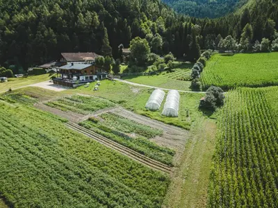 an aerial view of a farm with two hay bales at Der Hof - Perntal Retreat in Gais