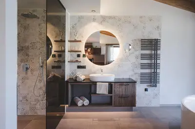 a bathroom with a sink and a mirror at Der Hof - Perntal Retreat in Gais