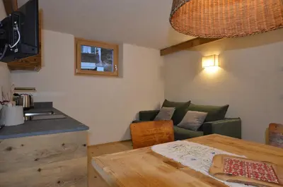 a living room with a couch and a table at Dolomiti charme in Cortina dʼAmpezzo