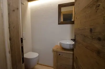 a bathroom with a toilet and a sink at Dolomiti charme in Cortina dʼAmpezzo