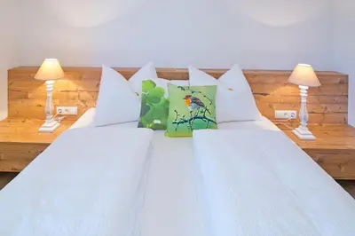 two beds in a room with two lamps at Wibmerhof in Tesido