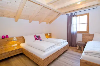 a bedroom with two beds and a window at Wibmerhof in Tesido