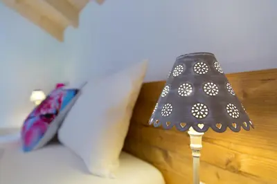 a lamp sitting on a couch with a pillow at Wibmerhof in Tesido