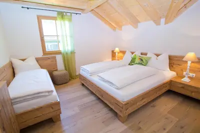 a bedroom with two beds and a window at Wibmerhof in Tesido