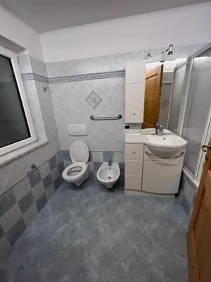 a bathroom with two toilets and a sink at Cèsa Sot Bosch in Canazei