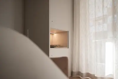 a bedroom with a mirror next to a window at Avista Apartments Terme in Merano