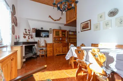 a kitchen with a table and chairs in a room at Le Ginestre in Alleghe