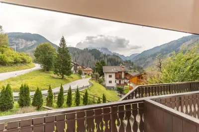 a balcony with a view of a road and mountains at Le Ginestre in Alleghe