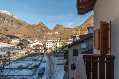 a view from a balcony of a town in the mountains at Appartamento Tre Valli 5 in Alleghe