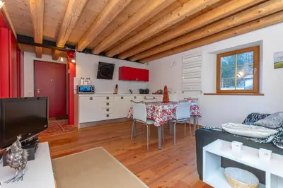 a living room with a couch and a table at Appartamento Tre Valli 5 in Alleghe