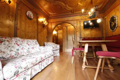 a living room with a couch and a table at Chalet Ampezzano di Marisa in Cortina dʼAmpezzo