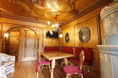 a dining room with wooden walls and a table and chairs at Chalet Ampezzano di Marisa in Cortina dʼAmpezzo