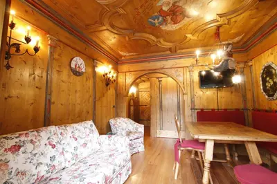 a living room with a couch and a table at Chalet Ampezzano di Marisa in Cortina dʼAmpezzo
