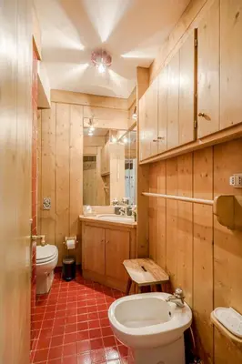a bathroom with a toilet and a sink at Dolce Casa Cortina Centro-Ski in Cortina dʼAmpezzo