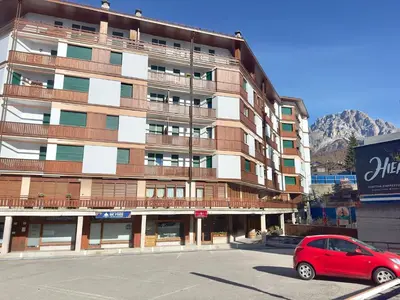 a red car parked in front of a building at Dolce Casa Cortina Centro-Ski in Cortina dʼAmpezzo