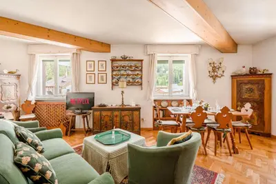 a living room with green furniture and a table at Dolce Casa Cortina Centro-Ski in Cortina dʼAmpezzo