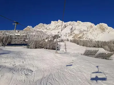 a ski lift in front of a snow covered mountain at APARTMENT - Ski in&out-accesso diretto alle piste in Cortina dʼAmpezzo