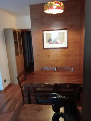 a dining room with a wooden table and chairs at Ca' Ravagnan in Cortina dʼAmpezzo